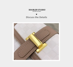 Detailed close-up of white checkered embossed leather with gold metallic buckle and brown trim