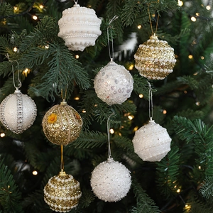Christmas tree ornaments with white and gold pearls and sequins for festive holiday decor