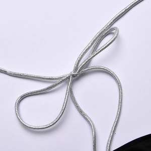 Detailed view of the silver braided strap tied in a knot on a solid color swimsuit