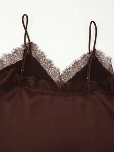 Detail of dark brown satin top with V-neck lace trim and adjustable shoulder straps