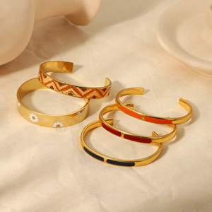 Golden stainless steel enamel open bangles set with floral and geometric patterns