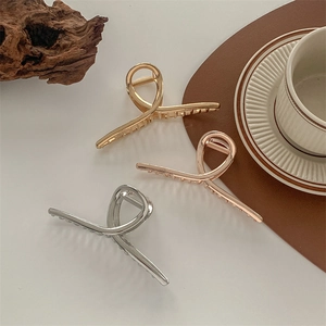 Set of three large metallic shark hair claws in gold, rose gold, and silver finishes