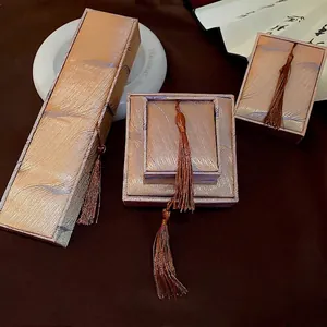 Elegant champagne silk jewelry box set with fringe tassels and minimalist vintage design