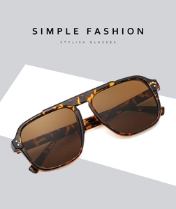 Detailed view of tortoiseshell frames and brown lenses on large pilot sunglasses