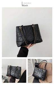 Detail of black quilted tote bag showing vintage chain strap and elegant rhombus stitching