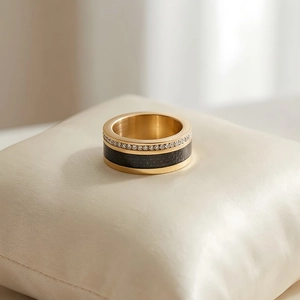 Detail of gold titanium ring with black enamel and double-row sparkling zircon crystals