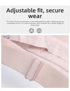 Detail of adjustable pink plastic buckle and elastic strap on the sun visor cap