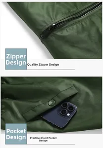 Detail of high-quality zipper and practical snap pocket on a green bomber jacket