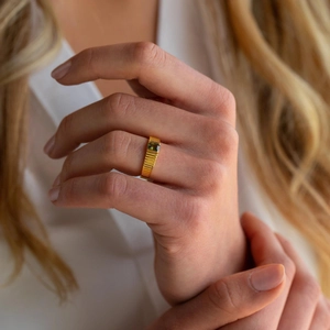 Gold-plated open ring featuring a rectangular emerald gemstone with vertical rib texture