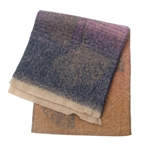Detail of soft jacquard scarf with ginkgo leaf pattern and fringe edges in gradient colors