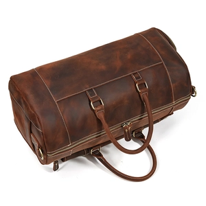 Top view of retro brown leather travel bag showing texture, dual handles, and zipper