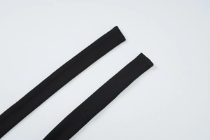 Detailed macro view of black knitted fabric texture and elastic straps for women's set