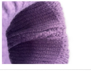 Detailed close-up showing the soft purple knitted texture of the children's winter beanie