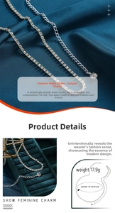 Detail of silver rhinestone waist chain with adjustable extender on blue silk fabric