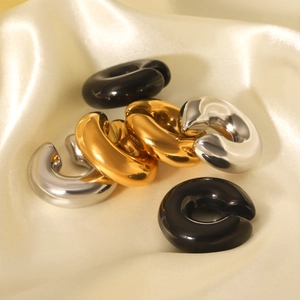 Three minimalist thick C-shaped ear cuffs in gold, silver, and black polished metal finishes