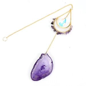 Detail of purple natural agate slice suncatcher with amethyst chips and golden metal chain