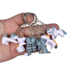Close-up of cute 3D plastic kitten keychains in various colors and cat poses