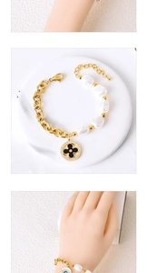 Detailed shot of a gold chunky chain bracelet with pearls and evil eye charms