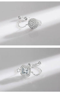 Detail of silver S925 rings with spherical zircon charms and long elegant shadows