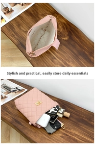 Interior view of pink quilted bucket bag showing storage space for phone and wallet