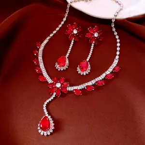 Elegant floral silver jewelry set with vibrant red crystals and pear-shaped drops