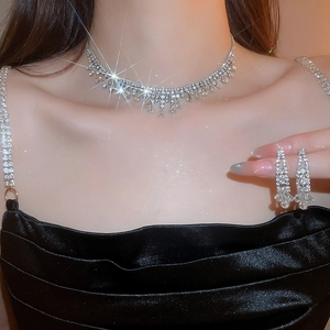 Elegant silver tassel necklace and teardrop earrings set worn by a model in soft lighting