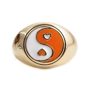 Detail view of heart-shaped Yin Yang ring with white and orange oil drip finish
