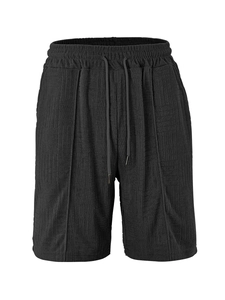 Detail of black sports shorts featuring breathable jacquard towel fabric and drawstring