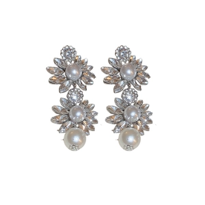 Silver flower earrings with rhinestones and pearls on white background