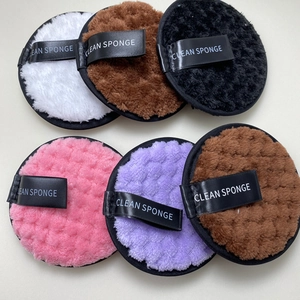 Detailed view of six colorful reusable round plush makeup removal puffs in assorted colors