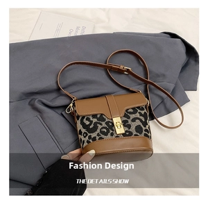 Detail shot of vintage bucket bag with leopard print stitching and golden twist lock closure