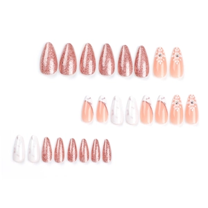 French almond press-on nails set with pink glitter and white marble snowflake designs