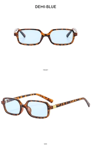 Detail view of demi-blue rectangular sunglasses with gold hinges in front and side views