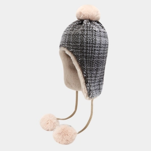 Detail view of American vintage winter trapper hat with three soft pom-poms and fleece lining