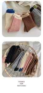 Detail of color-block ribbed wool socks in a rustic basket for autumn and winter warmth