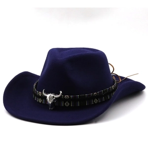 Detail of navy blue felt cowboy hat featuring silver bull head metal accessory and woven band