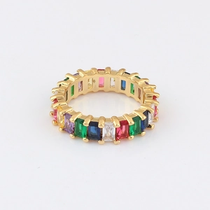 Macro view of gold eternity ring with rainbow baguette-cut cubic zirconia stones