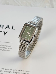 Detail of vintage green rectangular dial with silver stretch metal watch band