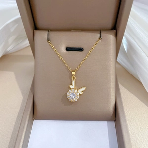 Golden dragon year necklace with sparkling diamond bow pendant in a jewelry box