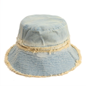 Light blue washed denim bucket hat with fringe edges and casual streetwear style