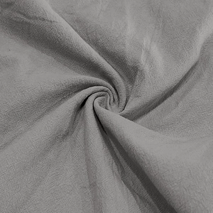 Close-up detail of grey linen fabric texture showing breathable weaving for men's shirt