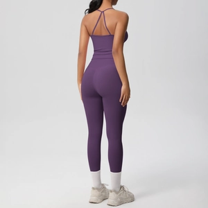 Detail of cross-back yoga bra and high-waist leggings in deep purple stretch fabric