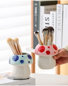 Close-up of cute mushroom ceramic pen holder showing glossy finish and dotted patterns