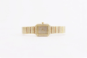 Detailed view of women's gold square watch featuring full rhinestone embellishments