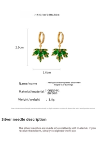 Macro detail of emerald maple leaf earrings with gold plating and cubic zirconia