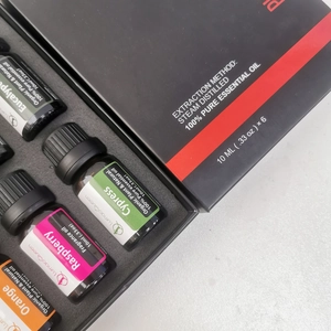 Top view of a gift set with 6 bottles of 10ml pure organic essential oils in a black box