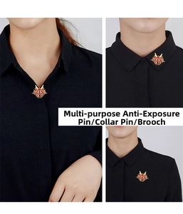 Macro detail of red and gold dragon brooch used as an anti-exposure pin on a black shirt