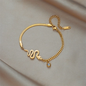 Gold snake pendant bracelet featuring a blend of snake bone and ring chain designs