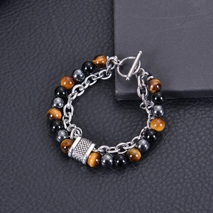 Detail of men's tiger eye and black obsidian beaded bracelet with stainless steel OT clasp
