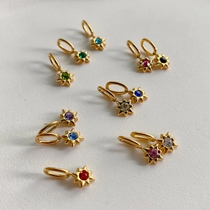 Detailoverzicht van diverse 14K vergulde sterhangers met gekleurde zirkoniasteentjes